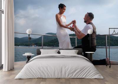 The moment of a marriage proposal on a yacht. Wall mural