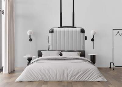 A white suitcase with a black handle sits on a white background Wall mural