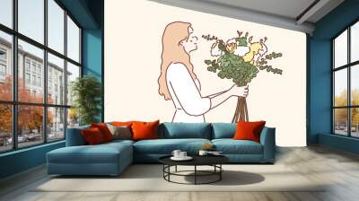 young woman in dress holding flowers. Hand drawn style vector design illustrations. Wall mural