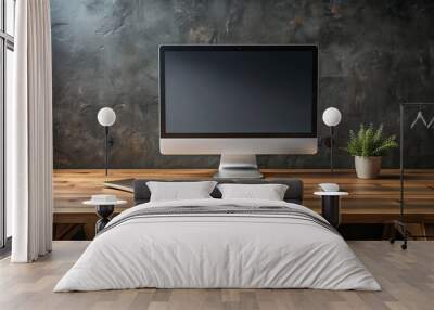 Modern computer with sleek design on a rustic wooden desk against a dark wall, featuring a blank screen perfect for customizing with your digital content. Wall mural