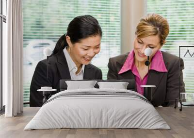 businesswomen reviewing paperwork in conference room Wall mural