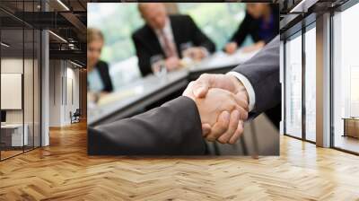 Close up of businessmen shaking hands in conference room Wall mural