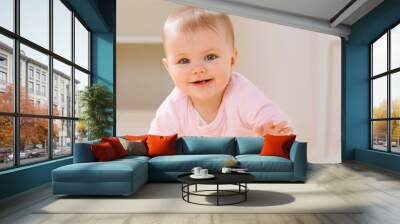 close up of smiling baby crawling on livingroom floor Wall mural