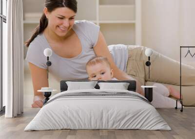 mother and baby playing with blocks on livingroom floor Wall mural