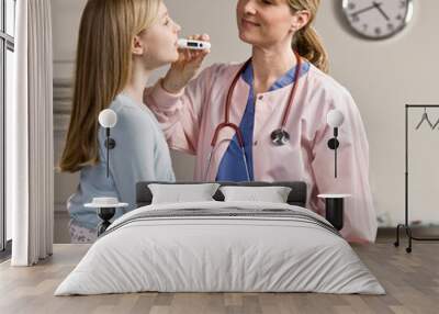 nurse taking sick patients temperature with thermometer Wall mural