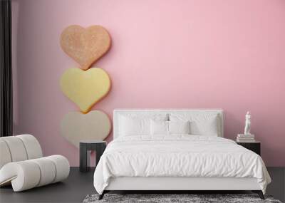 Heart shaped pink bar of soap on a light pink background. Top view, copy space. Heart shaped soaps. Importance of personal hygiene care. Copy space. Wall mural