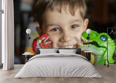 portrait of a child smiling while being kissed by two dinosaurs with selective focus Wall mural