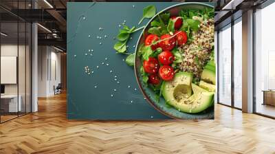 Fresh salad bowl with avocado, cherry tomatoes, and quinoa on a green table Wall mural