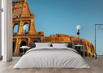 Colosseum at sunset in Rome, Italy. Ancient Roman Colosseum is one of the main tourist attractions in Europe. View of Colosseum in Rome during sunset. Wall mural