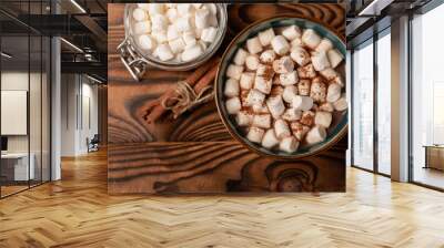 Cup of tasty cocoa drink and marshmallows in blue cup.Spices and marshmallows for winter drinks on brown texture table.Winter hot drink.Hot chocolate with marshmallow and spices.Copy space. Wall mural