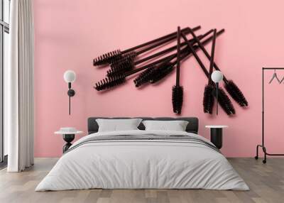 Eyelash extension brushes on a pink background. Brush for combing extended and false eyelashes. Brush for straightening eyelashes and eyebrows. Wall mural