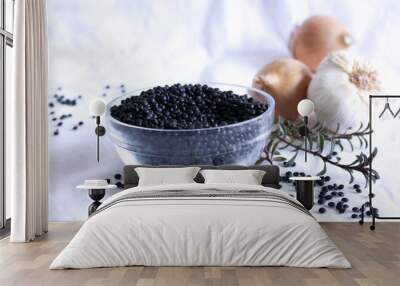 Heap of black organic beluga lentils in a glass bowl on white background.Just like the red lens, it does not need to soak it. Food concept. Wall mural