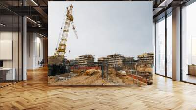 Large construction site including several cranes working on a building complex Wall mural