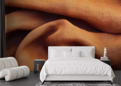 A wavy wallpaper surface made of orange fabric with wrinkles and folds. Wall mural