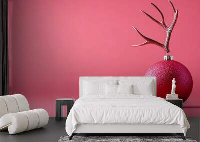 A pink background with reindeer horns and a pink ball for a Christmas decoration Wall mural