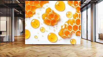 Isolated on a white background, sweet honeycomb slices fly in the air, accompanied by a few sticky bee puddles. Wall mural