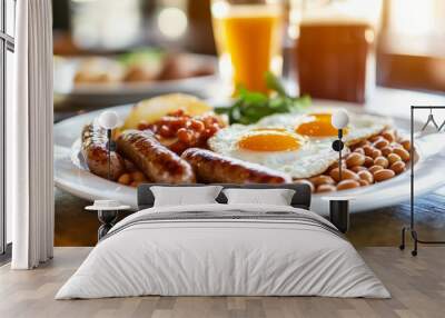 Served on a white plate with a pot of tea in the background, this English breakfast includes fried eggs, sausages, baked beans, and grilled tomatoes Wall mural