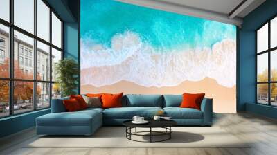 Stunning overhead shot of a tropical beach with crashing waves and golden sands. Wall mural