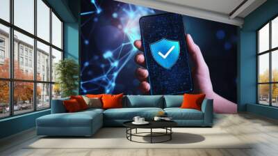 Symbolizing cybersecurity and data protection with smartphone in hand and digital shield icon. Wall mural