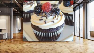 These chocolate cupcakes are topped with cream, berries, and mint leaves. Wall mural