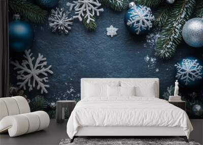 Winter decoration with frosted pinecones and greenery in blue and silver on dark background Wall mural