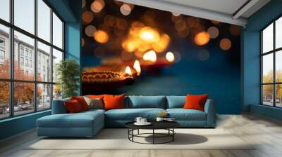 Colorful clay diya lamps lit during diwali celebration, selective focus Wall mural