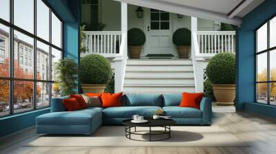 A white railing and potted plants decorate the porch of a house entrance Wall mural