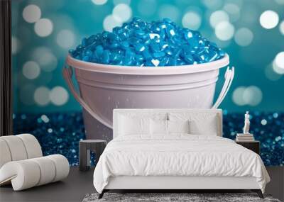 An inviting display of bright blue round tablets in a white cup against a shimmering blue background Wall mural