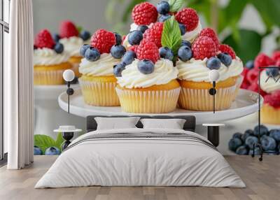 Dessert display with cupcakes, fresh berries, and elegant floral arrangements Wall mural