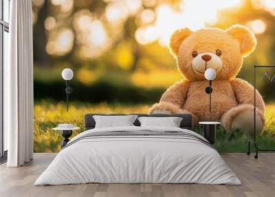 Having a relaxing sunset on grass with a teddy bear sitting in warm sunlight Wall mural