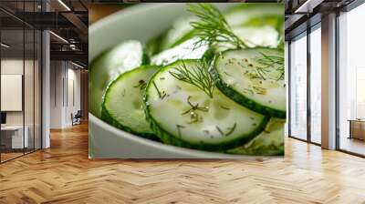 Sliced cucumbers in a white bowl, purple and green towels, and slices of cucumbers in a separate bowl Wall mural