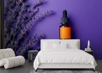 The perfume bottle sits next to lavender flowers on a table Wall mural