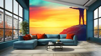 Young man enjoying freedom and life by the sea at sunrise, people travel wellbeing concept Wall mural