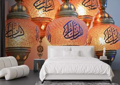 A close-up of illuminated mosque lanterns with traditional Arabic calligraphy, symbolizing the start of Muharram ul Haram. Wall mural