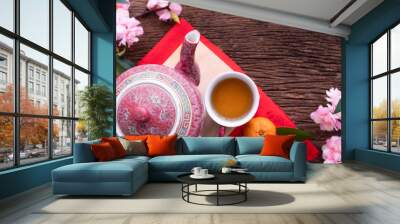 Wood table with cup of tea and Cherry blossom, Chinese new year celebration background. Wall mural