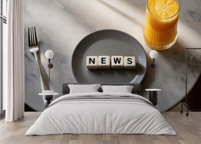 white letters “news” on cubes lie in a gray plate, top view, on a gray marble table, glass of orange juice, morning, sun rays Wall mural