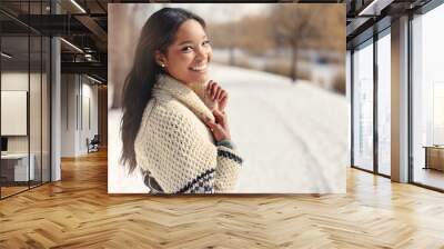 Beautiful young woman in the snow in winter Wall mural