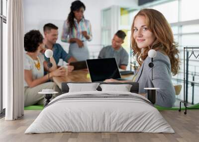 blond casual business woman using laptop during meeting Wall mural