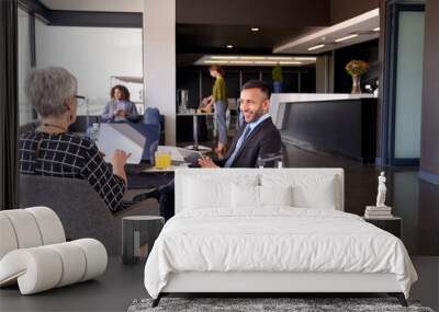 Diverse business partners sitting in modern airport lounge with Wall mural