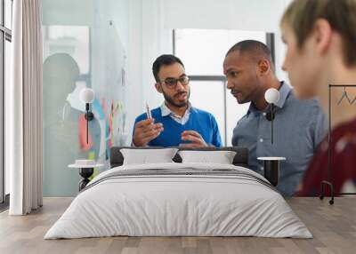 Indian man in a diverse team leading a brainstorming session Wall mural