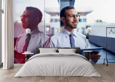 Millenial businessman leaning confidently on a dark glass wall with cityscape background Wall mural