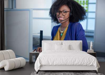 portrait of a smiling customer service representative with an afro at the computer using headset Wall mural