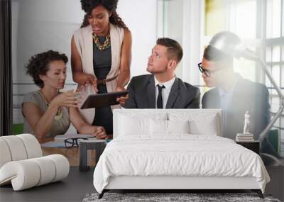 team of successful business people having a meeting in executive sunlit office Wall mural