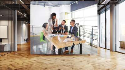 team of successful business people having a meeting in executive sunlit office Wall mural