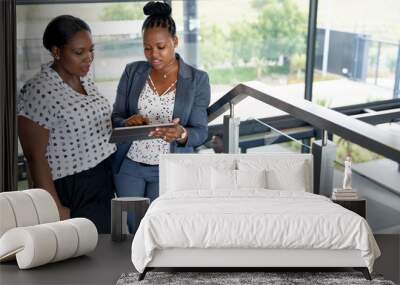 Two beautiful African American businesswomen in bright modern of Wall mural