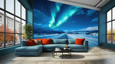 Northern lights shining above a snowy road Wall mural