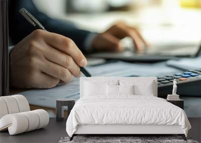 Person reviewing financial documents at a desk, focusing on company accounting and budget management Wall mural