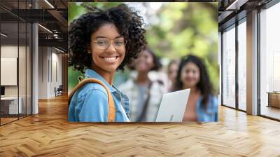 woman holding laptop and smiling. People friendship and technology concept. Education and campus theme. Group of friendship going to tutor together. Wall mural