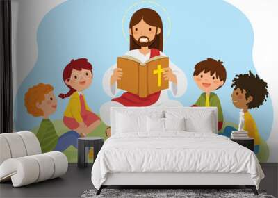 Jesus Christ reading the bible book to kids sitting on the grass. Wall mural