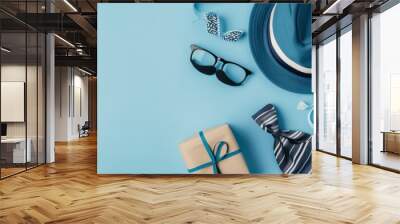 Fathers day banner with hat, glasses and tie on blue background Wall mural